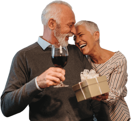 couple smiling holding a gift