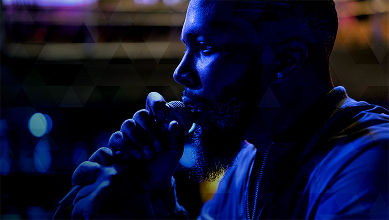 closeup of a man singing into a microphone at b.b. kings blues club
