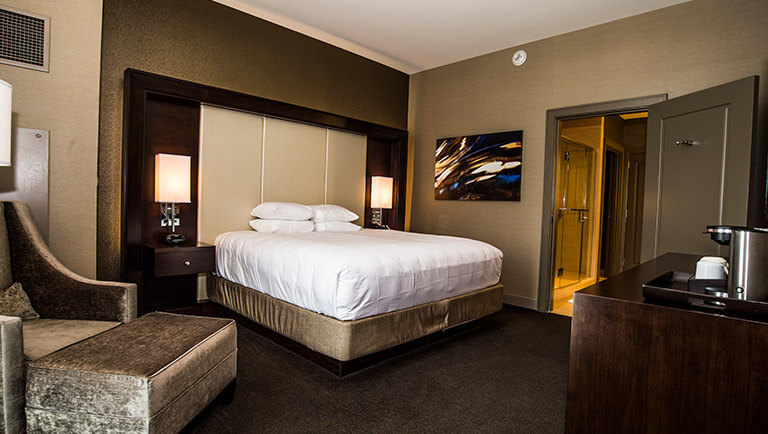 view of the king-size bed next to the entrance to the bathroom